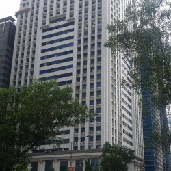 AIC Burgundy Empire Tower has a tall cuboid structure and an exterior of white concrete. The concrete surface has an array of many square recesses where windows can be found. The photograph was taken while standing on the sidewalk of Ortigas Avenue near the Zalameda St. Gate 1 of Corinthian Gardens.