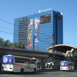 Alphaland Southgate Tower is a cuboid building covered primarily with blue glass panels and some billboards. This picture was taken while riding a bus approaching Chino Roces on the southbound side of EDSA.