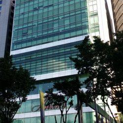 The Anson's Center in Ortigas Center is rectangular with a facade of green glass windows. There are segments of gray concrete that divides the floor, but the higher floors have fewer of these concrete segments and more of the glass surface. The word Anson's in red signage is between the second and the third concrete segment from the ground.