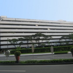 The Atrium of Makati's facade is concrete. It features horizontal bands of recessed areas on each floor where the windows are located. This is the view of the Atrium of Makati from the sidewalk at the corner of Paseo de Roxas and Villar St.