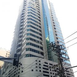 The concrete face of Chatham House's lower floors features open-air windows on the lower floors and glass exteriors on the middle and higher stories. This is Chatam House as seen from the opposite corner.