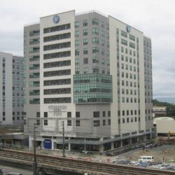 Cyberpod Two is a concrete cube-shaped building with darker shades at the corners and a glass-panelled protrusion on one corner. Cyberpod Centris Two as seen from the roofdeck of C & E Publishing building.
