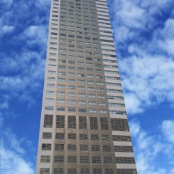 Cyberscape Beta as seen from ADB Avenue. It is a tall building with a concrete facade and windows forming a seven-column formation. The ground floor has entrances that are partly visible in this photograph.