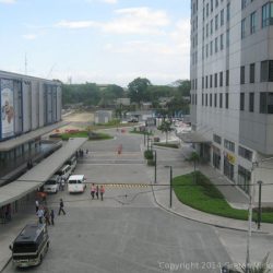 This photo is the driveway between Centris Sation and Cyberpod Centris. Centris Station is a mall situated at the corner of Quezon Ave. and EDSA; parts of it are visible on the left side of the picture. The taller building on the right side of the driveway is the Cyberpod One. This picture was taken from the northbound side of the MRT Quezon Avenue Station.