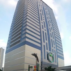 The Greenfield Tower is a tall blocky building with a facade made of blue glasses and gray concrete.