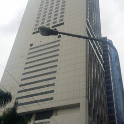 Marco Polo building is a very tall rectangular prism structure with a concrete exterior and few windows on the side. This is Marco Polo, as seen along Sapphire Road across Ortigas Building.