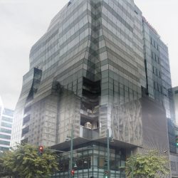 MDI Corporate Center is made of dark glass panels and wavy protrusions. The picture here was taken from the opposite corner of 10th Ave. and 39th St. with an upward-diagonal angle.