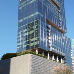 This is the Ore Central as seen from within the Track 30th. The structure is made if glass facade and looks like a stack of three L-shape buildings.