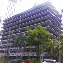 Ortigas Building is a low-rise 10-story building; this picture was taken from the island dividing the two sides of Meralco Avenue. Each floor from 2nd to 10th floor has rows of glass windows and concrete walls with an overhead design made of glass panels mounted on horizontal metal beams. The ground floor has glass and concrete walls with a concrete protrusion that can serve as cover to those standing in front of it. The words ORTIGAS BUILDING in a gray metallic material is seen on the front center of this concrete protrusion above the main entrance.