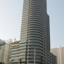 Paragon Plaza with curved architecture and horizontal line patterns. Shot from the EDSA southbound side while riding a bus passing by Petron station across Avida Towers Centera.